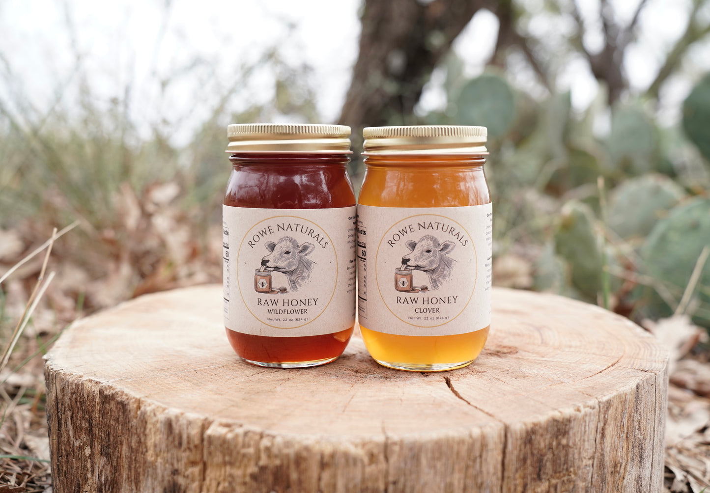 Two jars of Rowe Naturals raw honey on a wooden stump with a natural background.