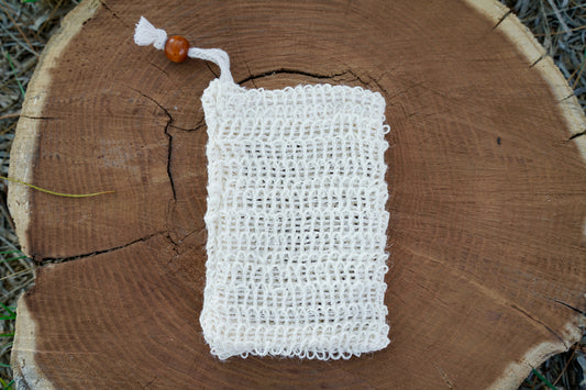 Sisal soap saver bag on a wood log